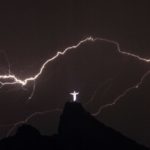 TOPSHOTSLightning flashes over the Christ the Redeemer statue on top of Corcovado Hill in Rio de Janeiro on January 14, 2014.    AFP PHOTO / YASUYOSHI CHIBA